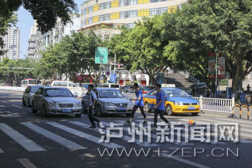 四川警察學(xué)院前的斑馬線沒有紅綠燈，但過往車輛見到有行人過斑馬線都會禮讓行人